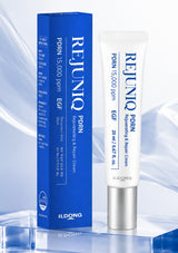A white tube and blue box of Ildong Rejunio PDRN Regenerating & Repair Cream, displayed on a reflective blue surface against a light blue abstract background.