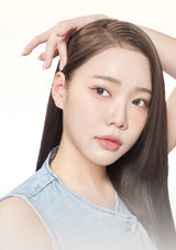 Woman with long hair and denim sleeveless top on a white background