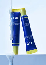 Two blue tubes with yellow caps labeled 'F:B' on a light blue background