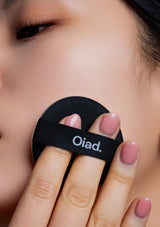 Person using a black Oiad tool on their face