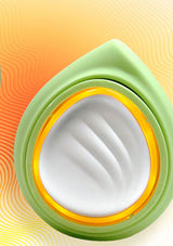Close-up of a green and yellow container with white cream on a colorful background