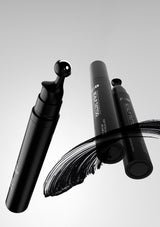 Black makeup brush with visible brand name on a gray background