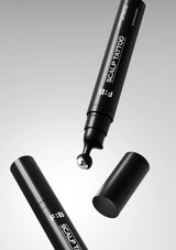 Black scalp tattoo pen with cap on a gray background