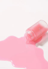 Pink lip balm with a visible brand name on a white background
