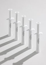 White dental syringes with 'Curettes' branding on a light gray background