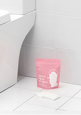 Pink package with a cartoon character on a white tiled floor