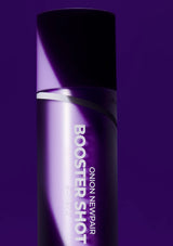 Purple bottle labeled 'Booster Shot' on a purple background
