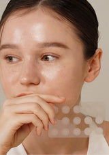 Close-up of a person with a neutral expression, focusing on the skin texture.