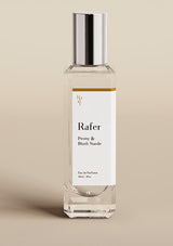 Rafer perfume bottle with a silver cap on a beige background