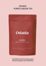 Red package of Odada Purple Moon Tea on a pink background