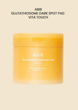 A beige cosmetic jar labeled 'Abib Glutathione Kojic AICD Eye Patch Vita Jelly' on a solid pale beige background, with additional text above reading 'ABIB GLUTATHIONE KOJIC AICD EYE PATCH VITA JELLY'.
