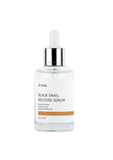 Black snail restore serum bottle with a white background
