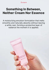 Hand holding a pink skincare tube with text about its texture and benefits on a light gray background