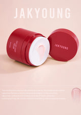 Red cosmetic container with white lid on a pink background, featuring the brand 'JAKYOUNG'.