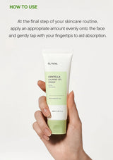 Hand holding a tube of iUNIK Centella Calming Gel Cream with usage instructions on a white background.