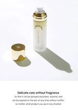 Cream mist bottle with gold cap on a white background