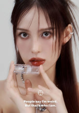 Person holding a clear compact mirror with text overlay