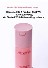 Pink bottle labeled 'every routine' with text about product ingredients on a white background
