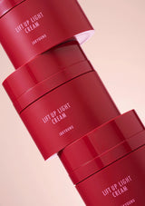 Red containers of 'Lift Up Light Cream' by Jinyoung on a beige background