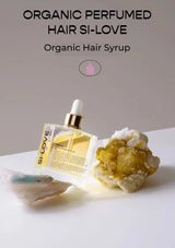 SI-LOVE organic perfumed hair syrup with a natural rock and crystal on a light background
