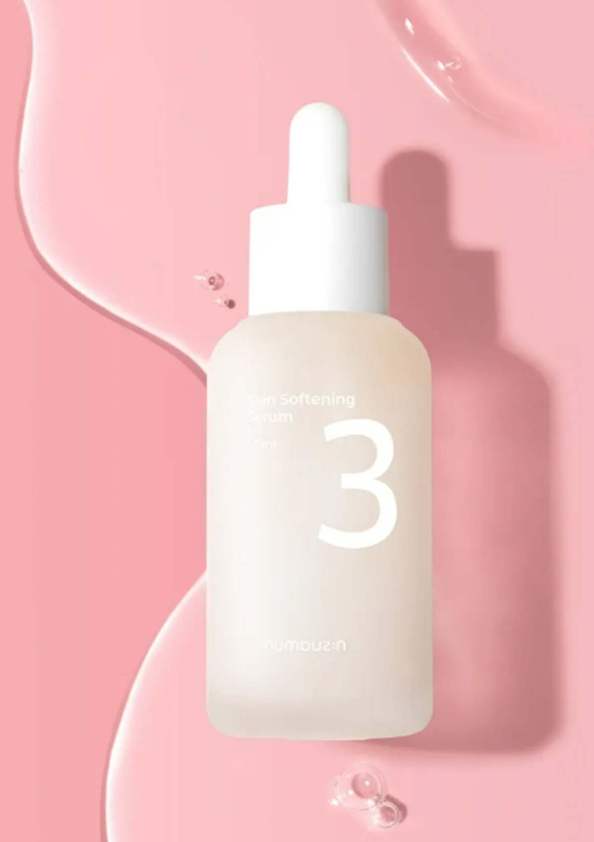 Skincare serum bottle with dropper on a pink background