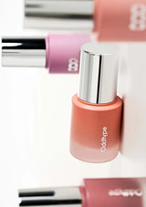 Pink lip gloss with silver cap on a white background