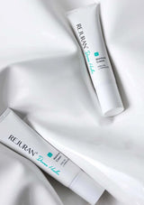 Two tubes of Rejuran Dermal Nuke cream on a white fabric background
