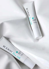 Two tubes of Rejuran Moisture Cream on a white fabric background