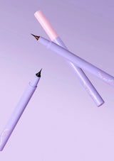 Two purple pens with gold accents on a light purple background
