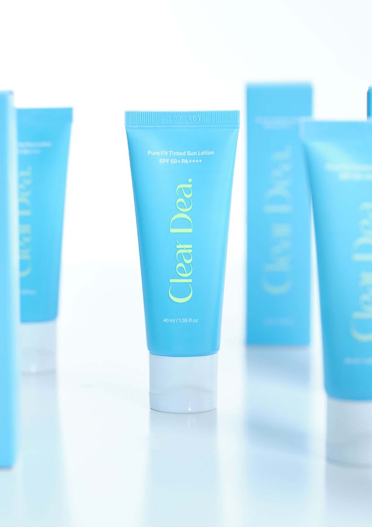 Set of blue skincare products with 'Clear Dea' branding on a light blue background