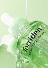 Torriden Balanceful Serum bottle with dropper on a light green background