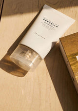 Skincare product with packaging on a wooden surface