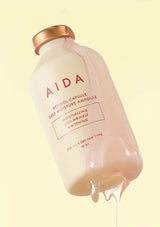Bottle of AIDA skincare product with a beige background