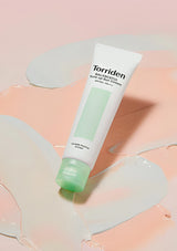 Tube of Torriden sunscreen on a pink and beige background