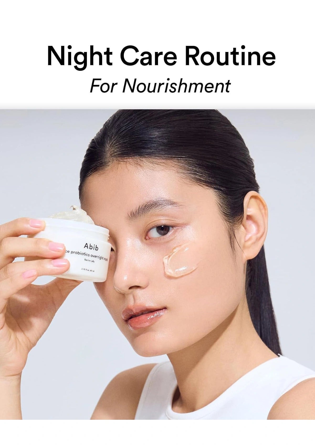 A woman holding a white cosmetic jar near her face while wearing a cream product on her cheek, with the text 'Night Care Routine For Nourishment' at the top.