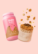 Shake Baby protein shake container with a scoop of powder on a pink background