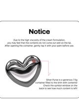 Silver heart-shaped container with text on a white background