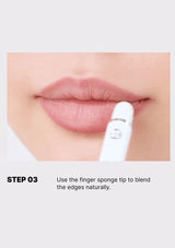 Lipstick application with a finger sponge tip on a white background