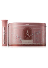 Pink skincare product set with a cylindrical container and a round tin on a white background