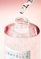 Bottle of Centella with dropper on a pink background