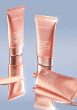 Two tubes of Medicube Collagen Firming Sun Cream on a reflective surface with a gradient blue background.