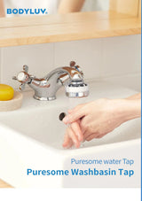 Bodyluv Puresome Washbasin Tap installed on a white sink with running water, shown with a hand washing beneath it. The blue Bodyluv logo appears at the top left, and product text is at the bottom.