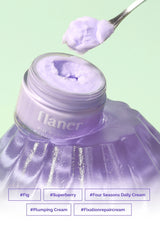 Flaner hair product with purple cream being scooped out on a light green background