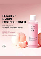 Anua Peach 77 Niacin Essence Toner bottle with peach slices on a pink background