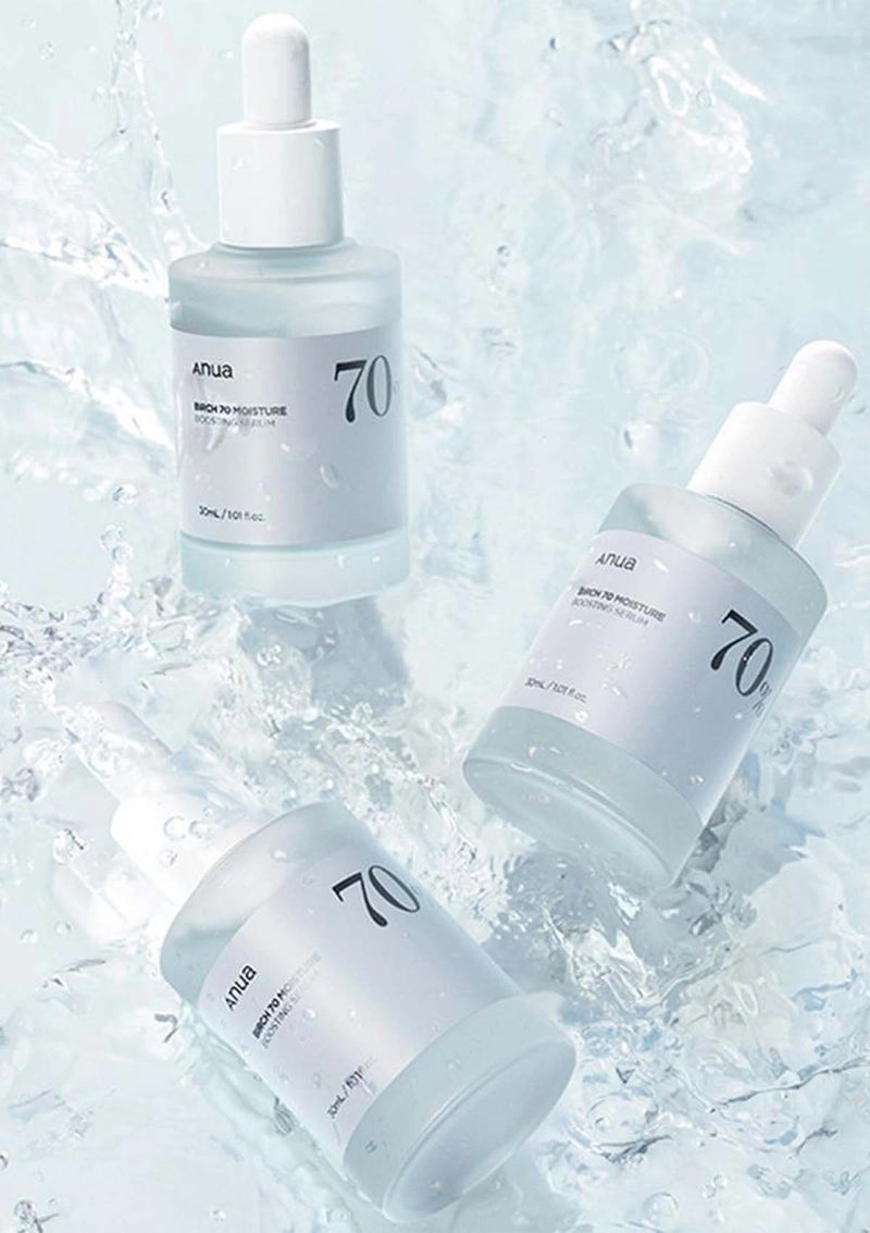 Three skincare droppers with '70' branding on a light blue textured background