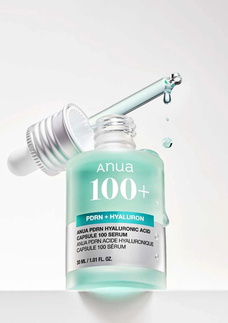 Anua 100+ serum bottle with dropper on a white background