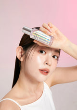 Woman holding a skincare bottle against a pink background