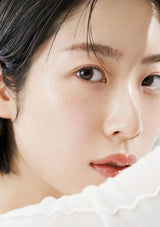 Close-up of a person with a neutral expression on a white background