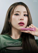 Person holding a pink lipstick with a neutral background