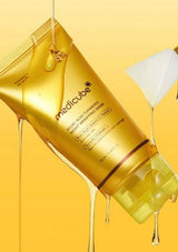 Medicube facial mask package with gold liquid on a yellow background